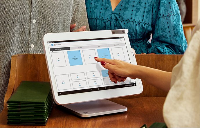 A customer signing on a countertop terminal